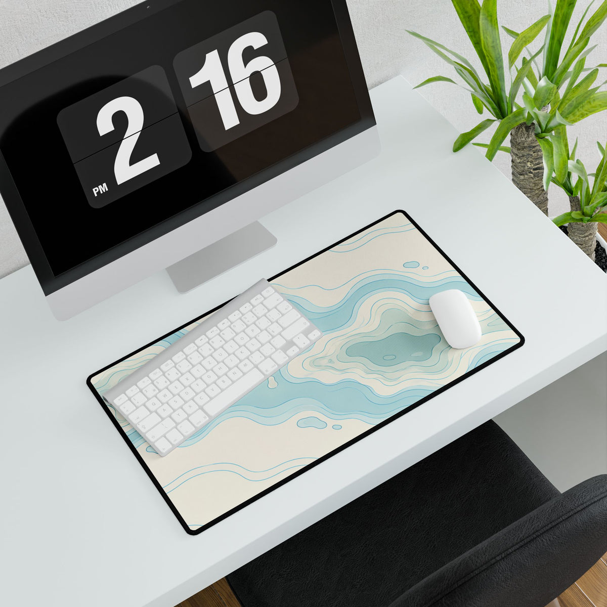 Coastal Blue Topographic Desk Mat, 23.6 × 13.8 in, angled computer desk mockup with plant.