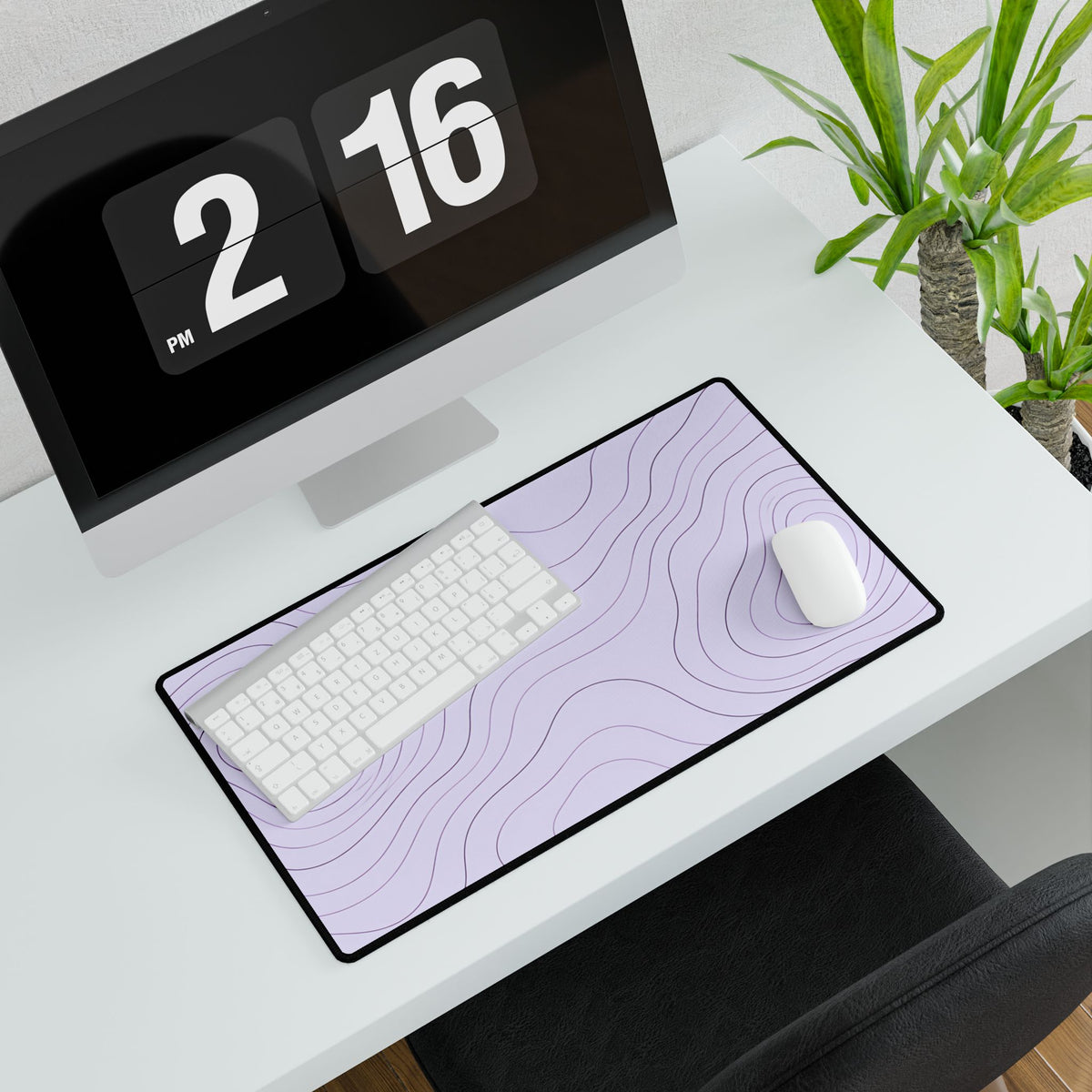Lavender Topographic Desk Mat, 23.6 × 13.8 in, angled computer desk mockup with plant.