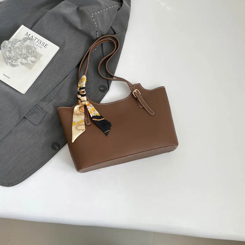 Shoulder tote bag with patterned scarf – Brown bag arranged beside a blazer | BTendance