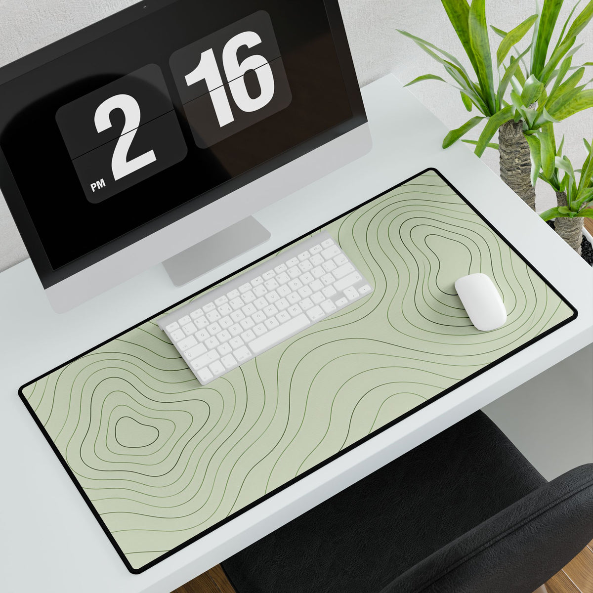 Sage Green Topographic Desk Mat, 31.5 × 15.5 in, angled computer desk mockup with plant.