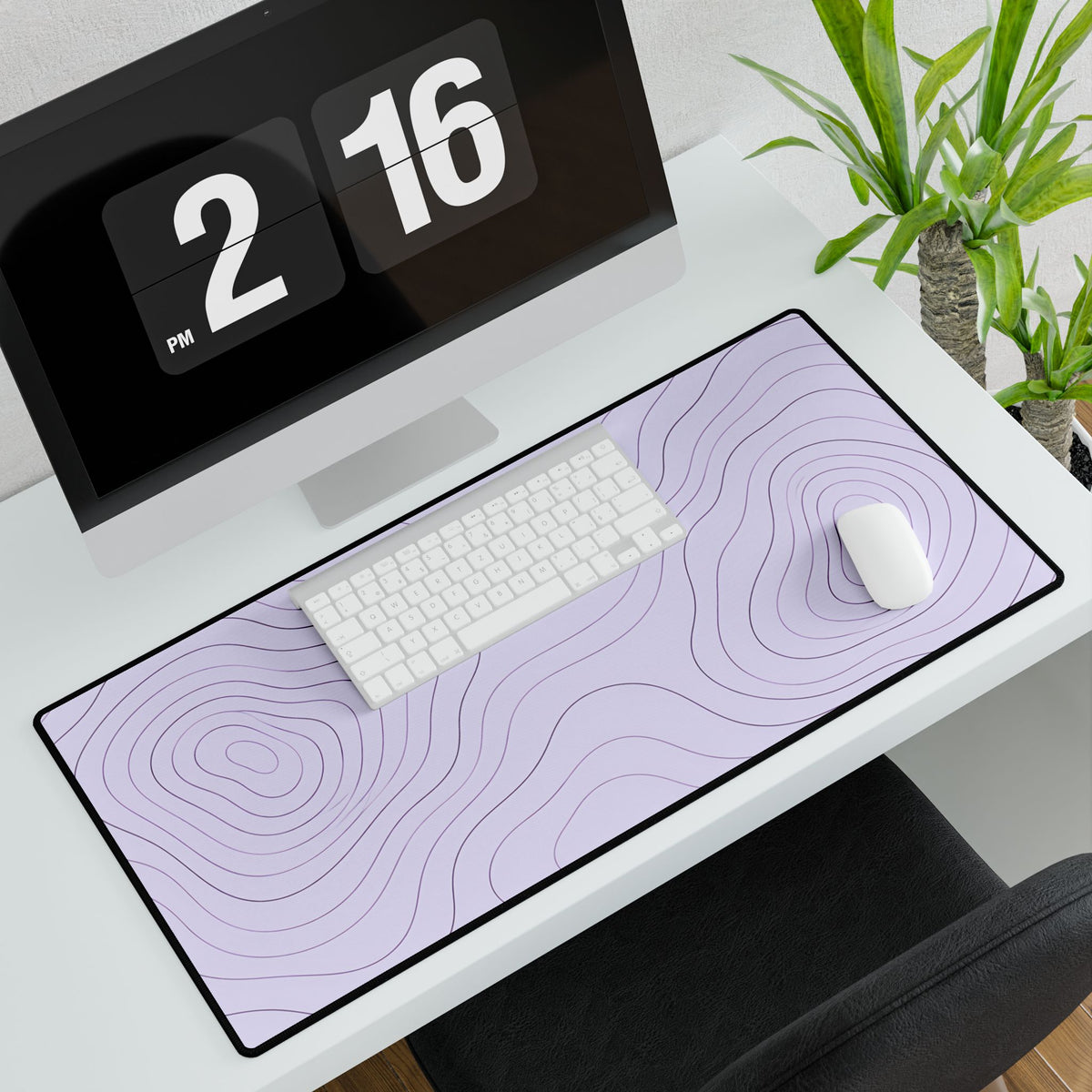 Lavender Topographic Desk Mat, 31.5 × 15.5 in, angled computer desk mockup with plant.