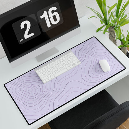 Lavender Topographic Desk Mat, 31.5 × 15.5 in, angled computer desk mockup with plant.