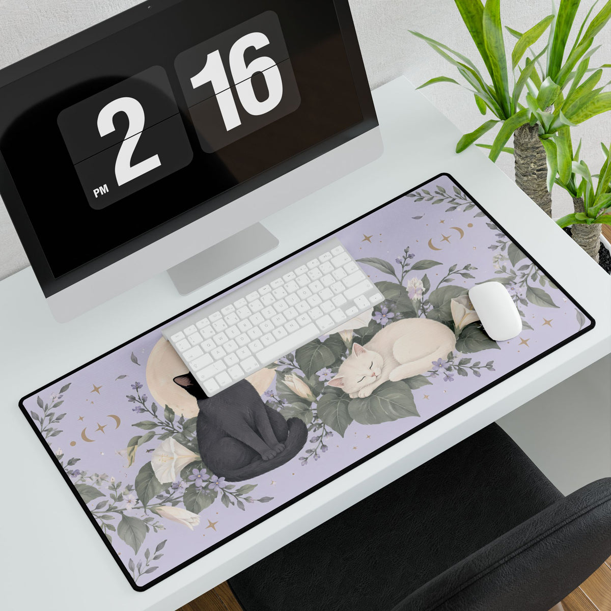 Moonflower Cats Desk Mat, 31.5 × 15.5 in, angled computer desk mockup with plant.