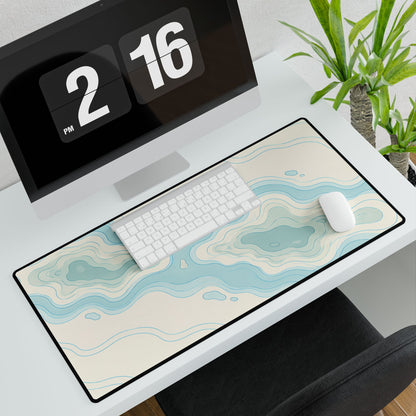 Coastal Blue Topographic Desk Mat, 31.5 × 15.5 in, angled computer desk mockup with plant.