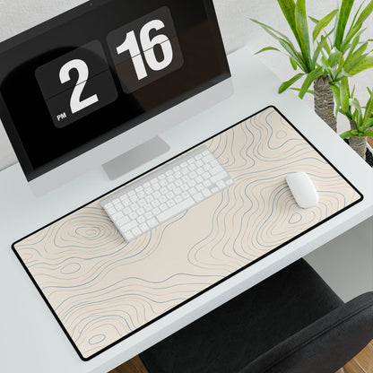 Ivory Topographic Desk Mat, 31.5 × 15.5 in, angled computer desk mockup with plant.