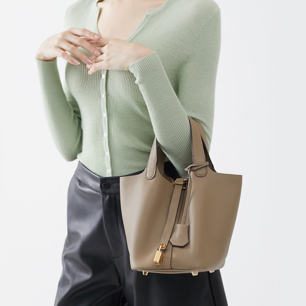 Soft Bucket Handbag – Twin Handles and Gold-Tone Detail — Brown, hand carrying for scale | BTendance