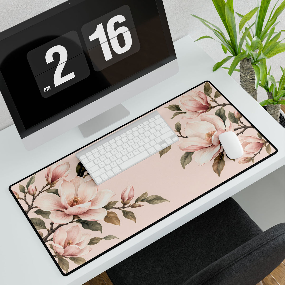 Blush Pink Magnolia Desk Mat, 31.5 × 15.5 in, angled computer desk mockup with plant.