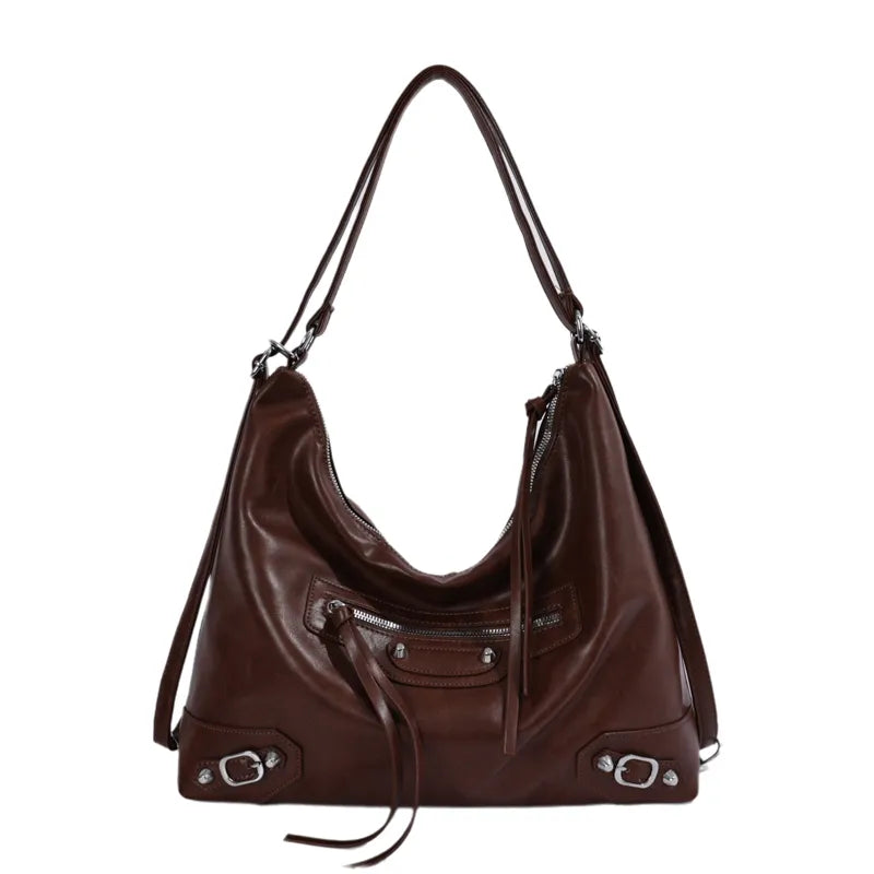 Slouchy shoulder bag with front zip and buckle details — warm brown on white background | BTendance