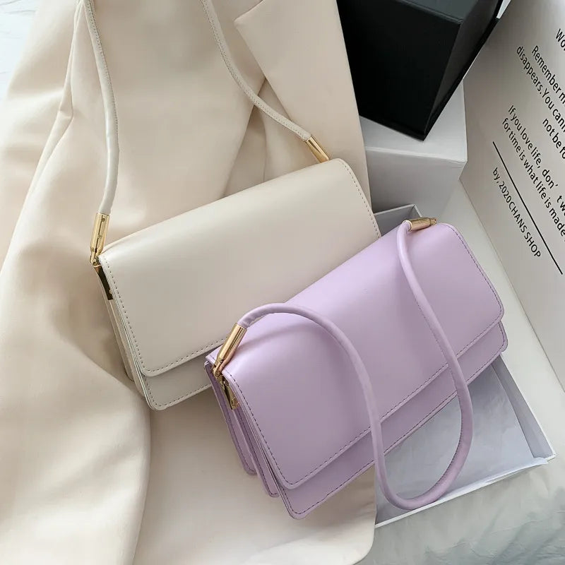 Slim rectangular flap shoulder bag with gold-tone strap accents — white and lilac displayed together | BTendance