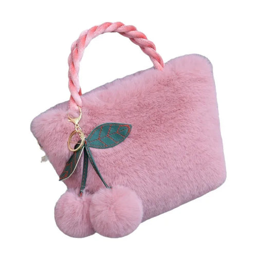 Plush handbag with twisted pink handles and pom-pom cherry charm — mauve on white background | BTendance