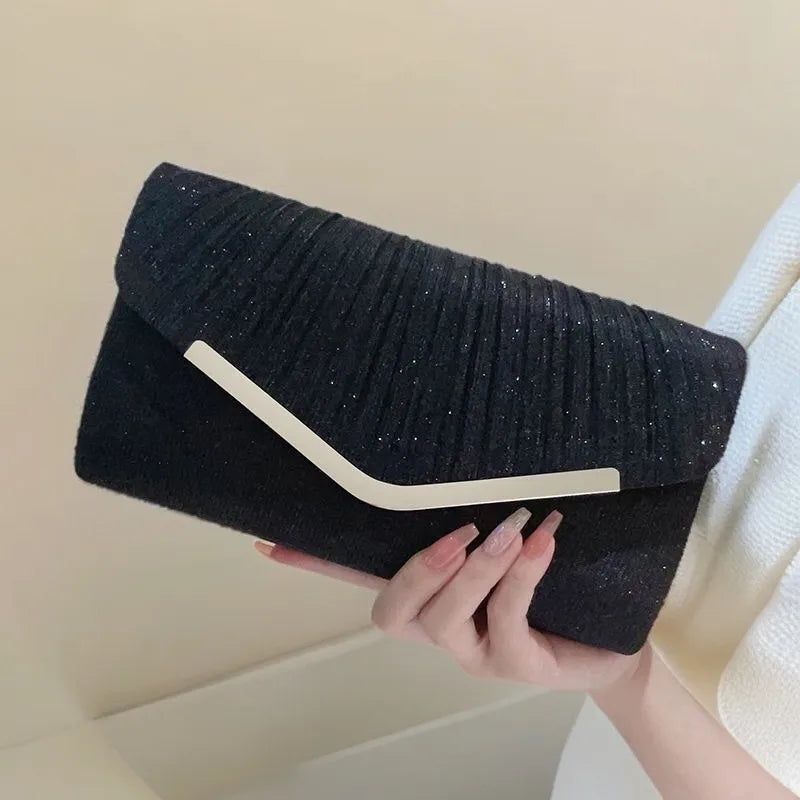 Pleated Envelope Evening Clutch with Metallic Trim – Black held for scale | BTendance