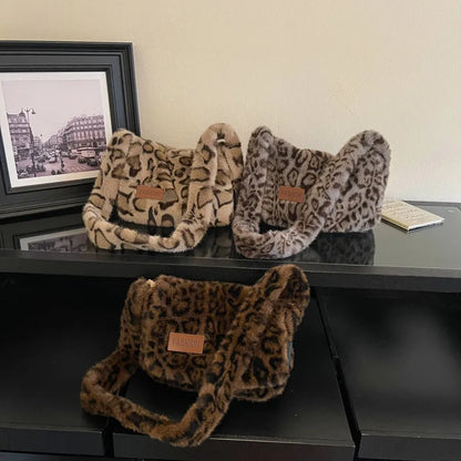 Leopard-print plush shoulder bag — three leopard-print colors arranged on cabinet | BTendance
