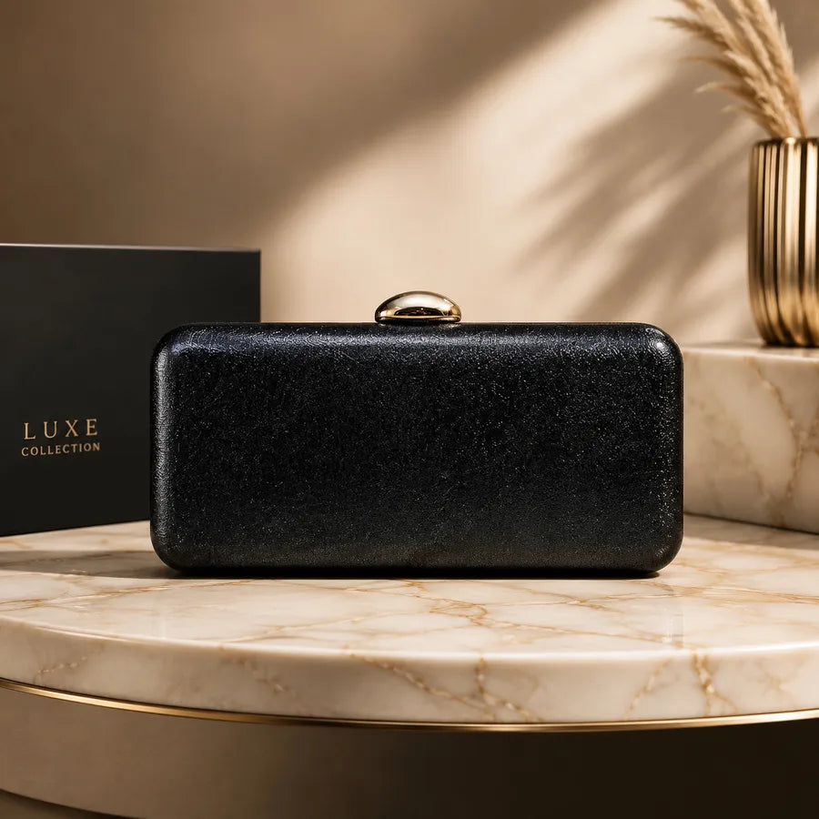 Rectangular evening clutch with oval metal clasp — black on marble display | BTendance