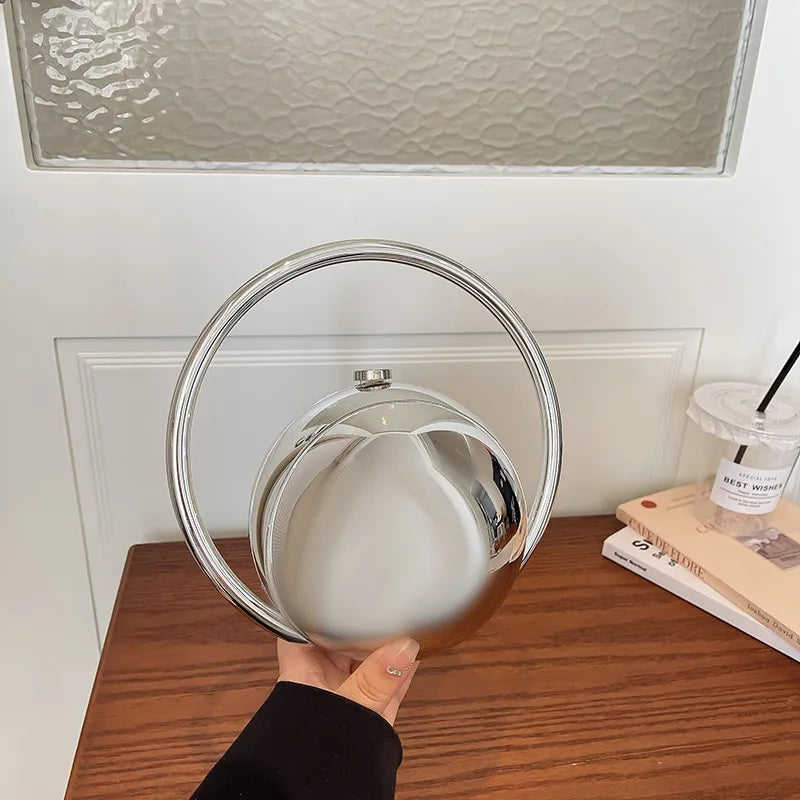 Round Acrylic Orb Bag with Faceted Ring Handle – Silver held for scale | BTendance