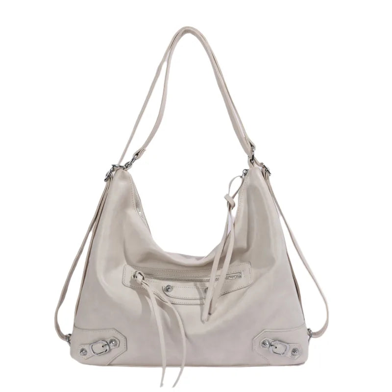 Slouchy shoulder bag with front zip and buckle details — cream on white background | BTendance