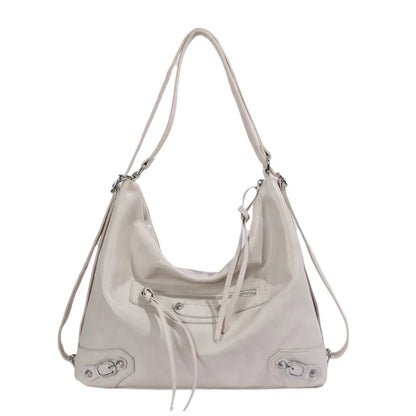 Slouchy shoulder bag with front zip and buckle details — cream on white background | BTendance