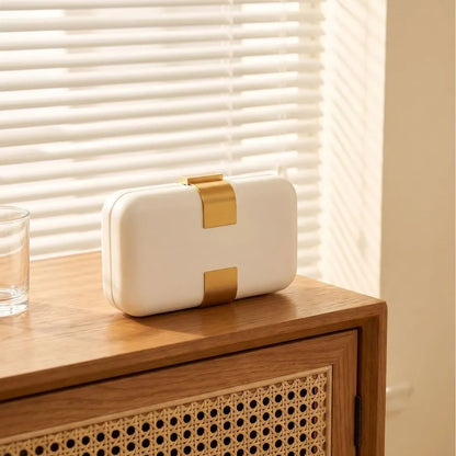 Rectangular evening clutch — ivory angled view on wooden cabinet | BTendance