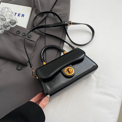 Structured top-handle flap handbag with round gold-tone clasp — black with extended shoulder strap | BTendance