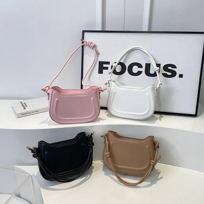 Curved shoulder bag with outlined front panel and knotted strap — four colors arranged on display | BTendance