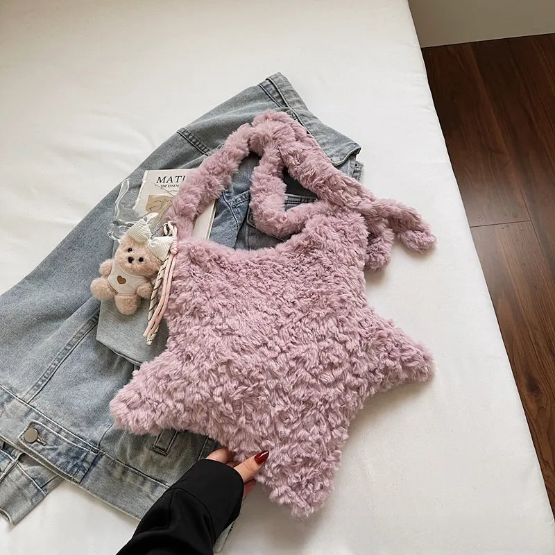 Star-shaped plush shoulder bag with small hanging charm — pink on denim display | BTendance
