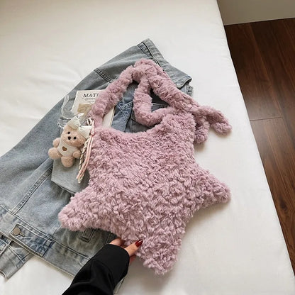 Star-shaped plush shoulder bag with small hanging charm — pink on denim display | BTendance
