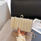 Women's Pearl-Effect Striped Evening Clutch – Gold held for scale | BTendance