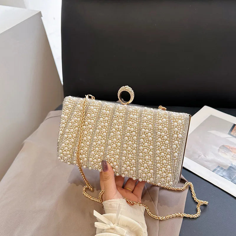 Women's Pearl-Effect Striped Evening Clutch – Gold held for scale | BTendance