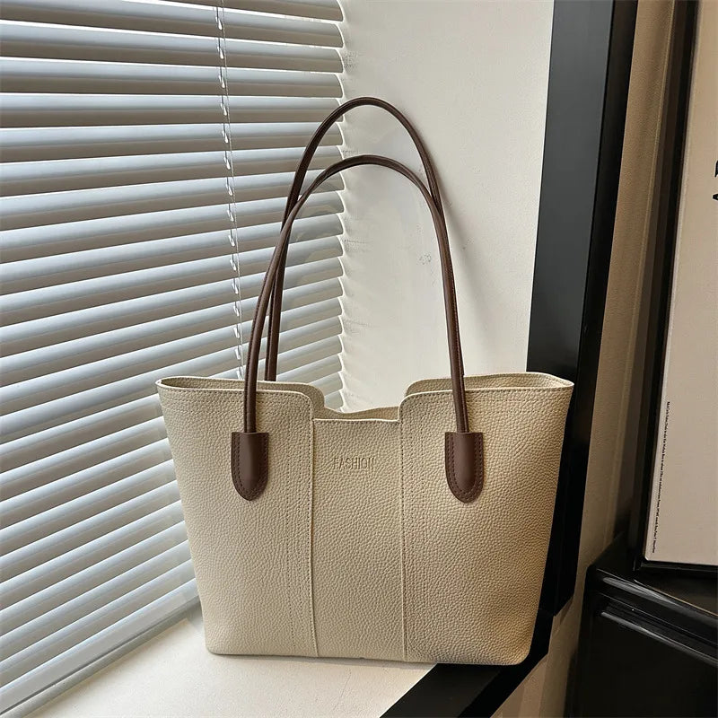 Structured tote bag with long handles – Cream bag with brown handles beside a window | BTendance