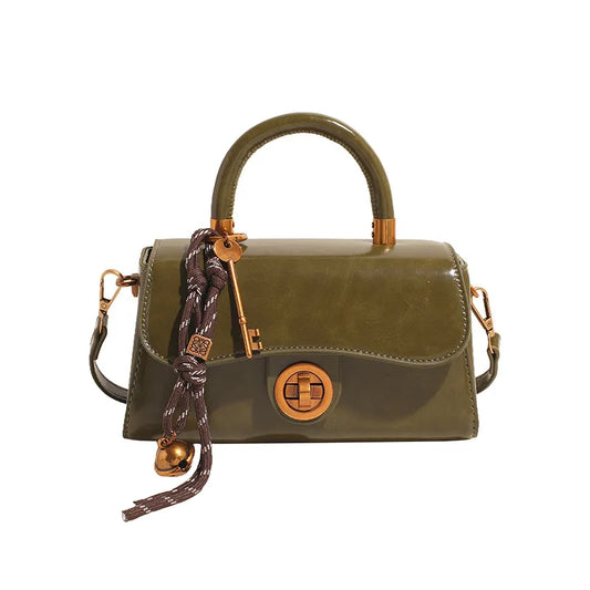 Structured top-handle flap handbag with round gold-tone clasp — green with scarf accent on white background | BTendance