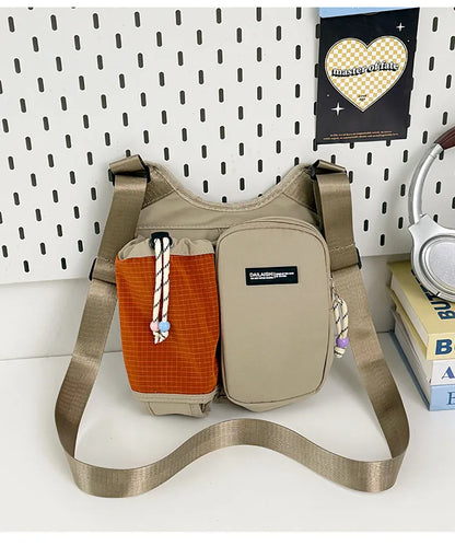 Crossbody bag with mesh bottle pocket and front zip pouch — beige with orange pocket on display | BTendance