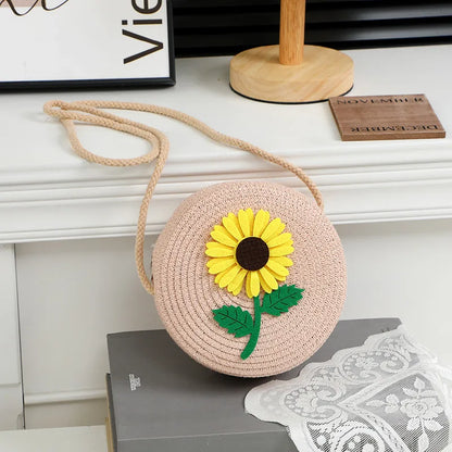 Round woven sunflower crossbody bag – Pink stem and leaf sunflower bag on a display table | BTendance