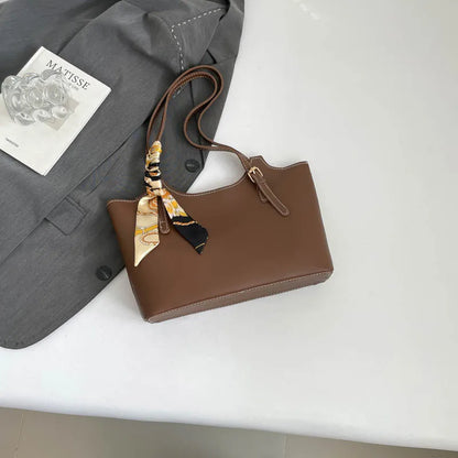 Shoulder tote bag with patterned scarf – Brown bag arranged beside a blazer | BTendance