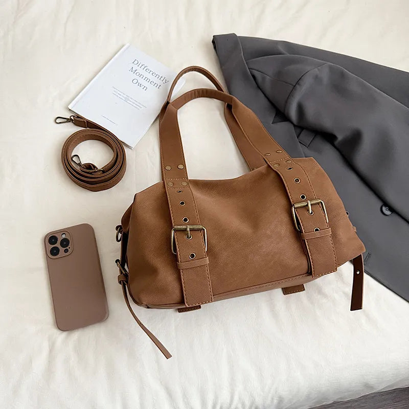 Buckle detail shoulder bag – Tan bag laid beside a phone | BTendance