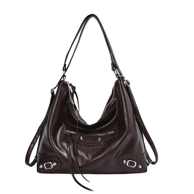 Slouchy shoulder bag with front zip and buckle details — dark brown on white background | BTendance