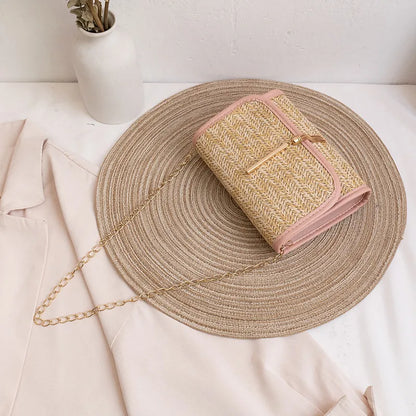 Woven flap crossbody bag with chain strap – Pink trim bag laid flat with chain strap | BTendance