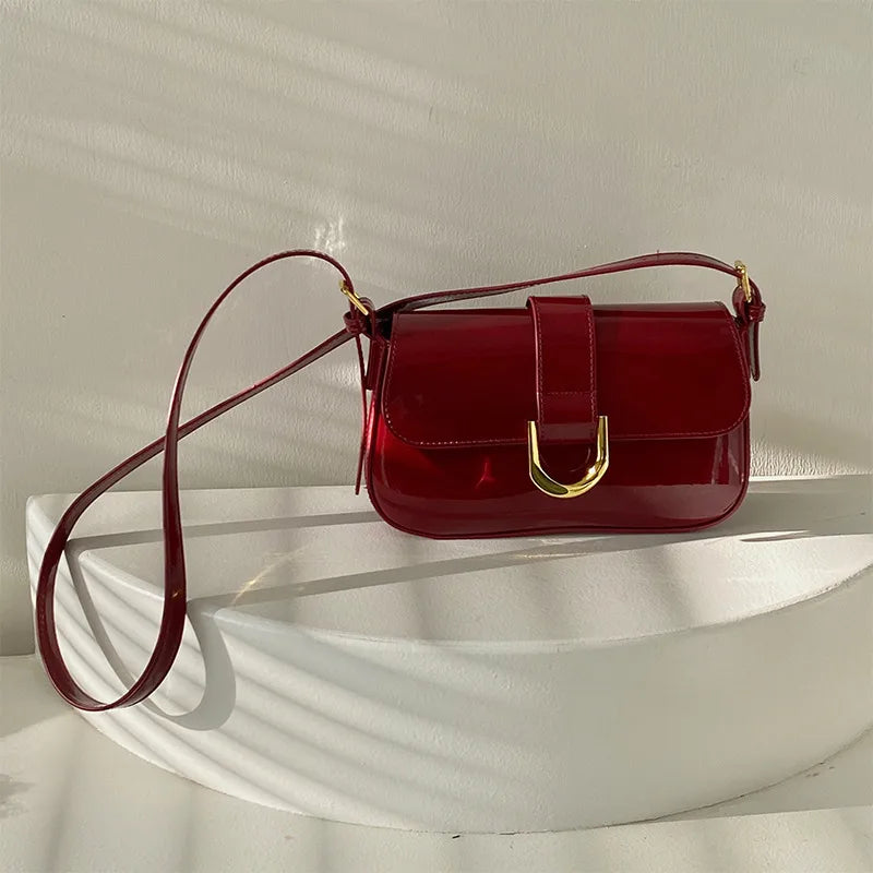 Flap shoulder bag with gold tone U clasp – Red bag displayed on a chair | BTendance