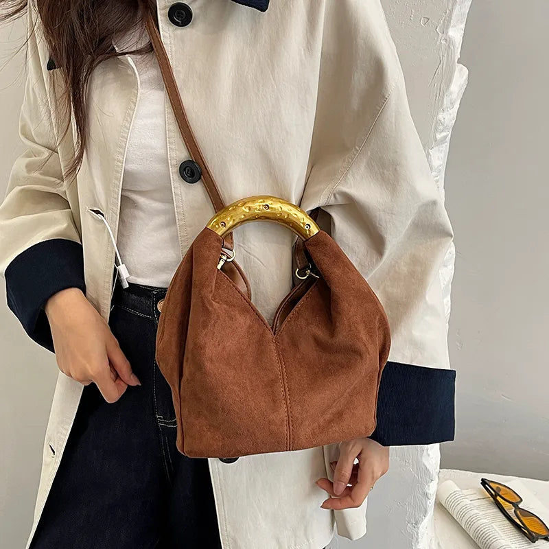 Suede-look bucket handbag with curved gold-tone handle — rust worn crossbody | BTendance