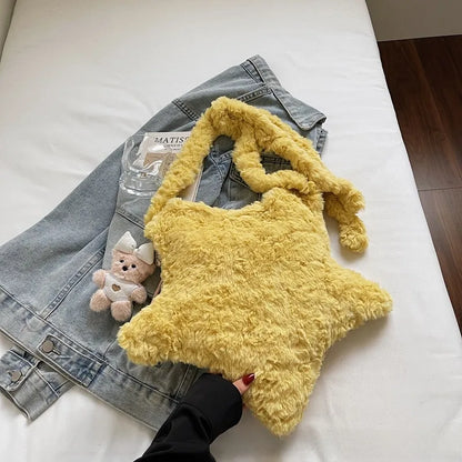 Star-shaped plush shoulder bag with small hanging charm — yellow on denim display | BTendance