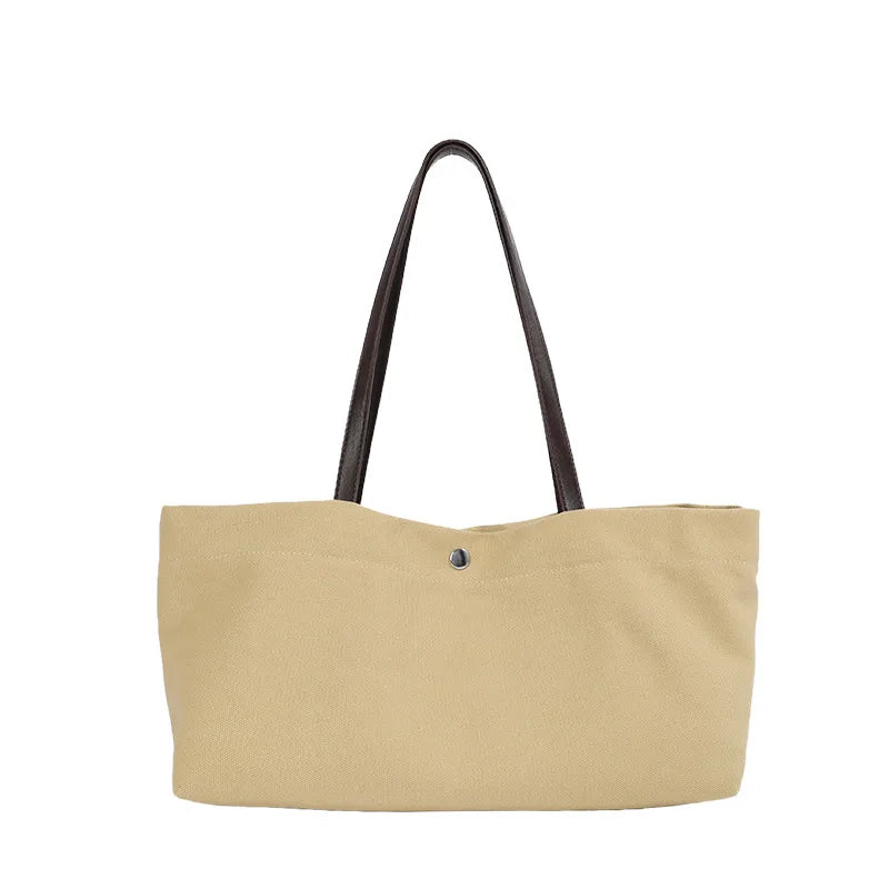 Wide canvas tote with contrasting dark shoulder handles — beige front view on white background | BTendance