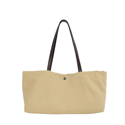 Wide canvas tote with contrasting dark shoulder handles — beige front view on white background | BTendance