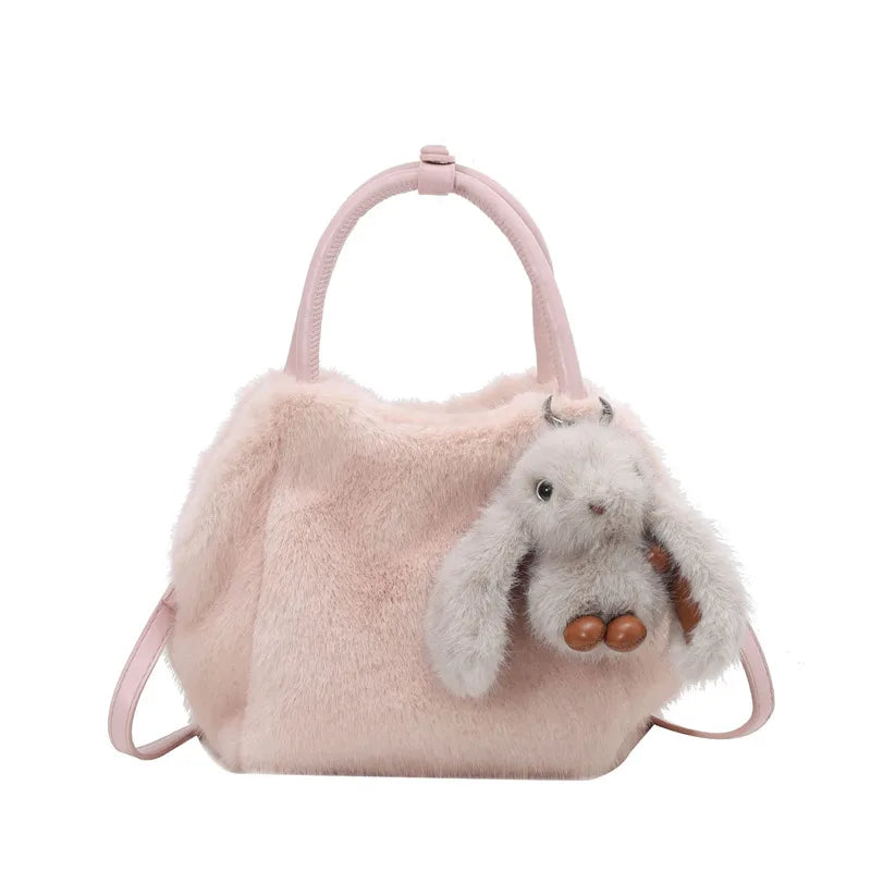 Plush top-handle handbag with rabbit charm — pale pink on white background | BTendance