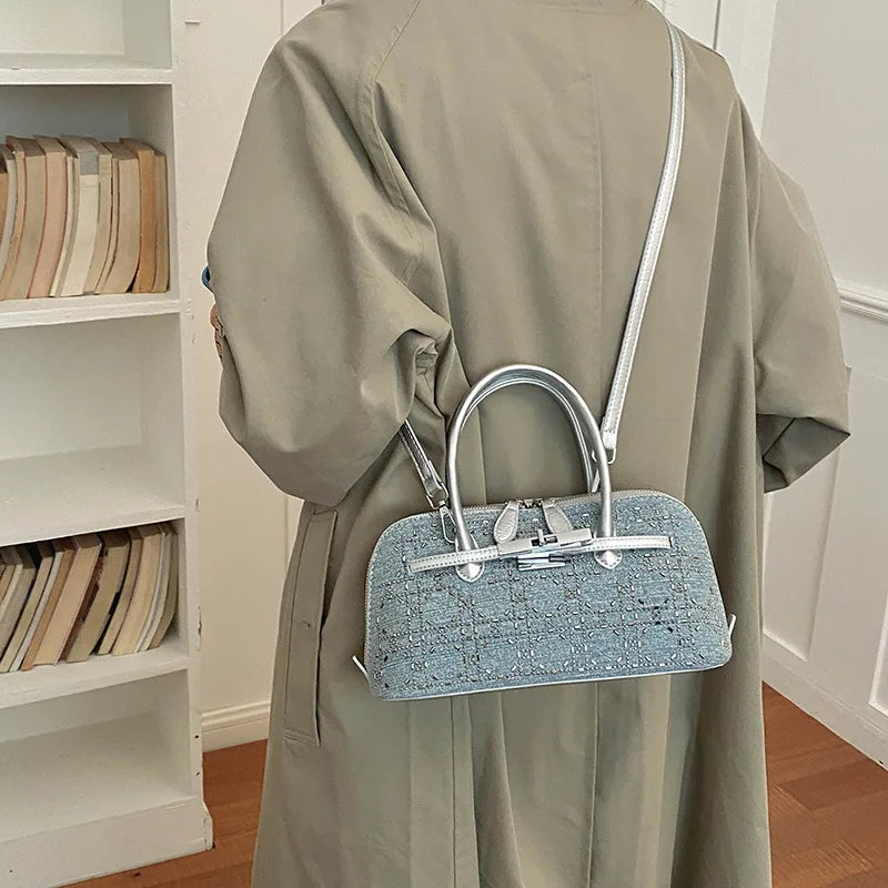 Denim handbag with silver-tone handles and shoulder strap — grid embellishments worn crossbody | BTendance