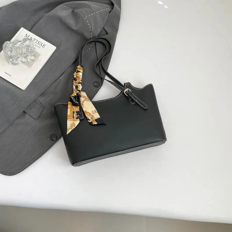 Shoulder tote bag with patterned scarf – Black bag arranged beside a blazer | BTendance