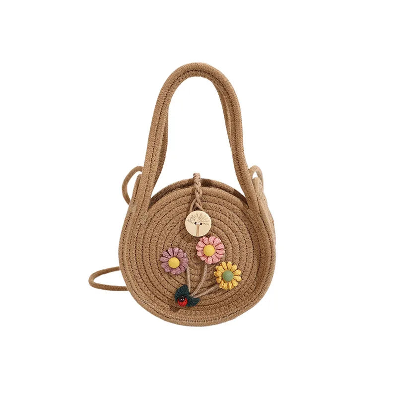 Round woven handbag with flower decoration – Tan flower bag on white background | BTendance