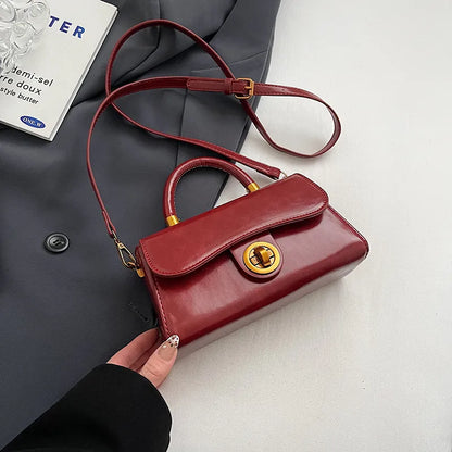 Structured top-handle flap handbag with round gold-tone clasp — red with extended shoulder strap | BTendance