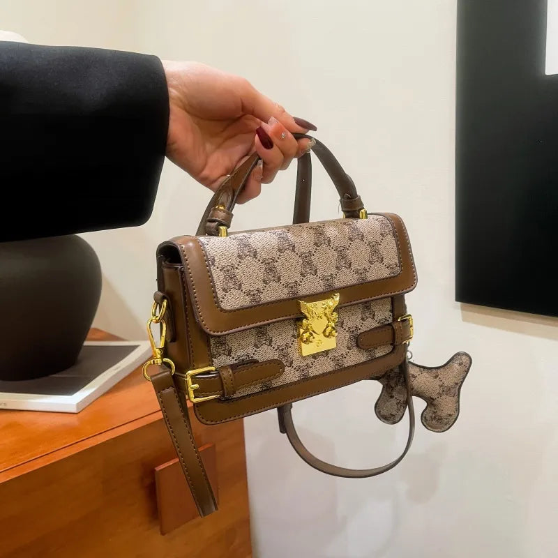 Bear pattern top handle bag with charm – Tan bag held by its top handle | BTendance