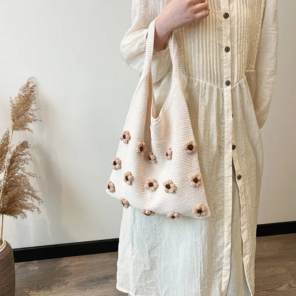 Flower applique knit shoulder tote – Brown flower tote held at the side | BTendance
