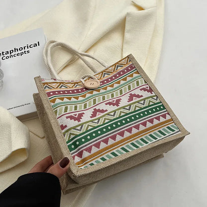Geometric patterned tote with rope handles – Tote laid flat on pale fabric | BTendance