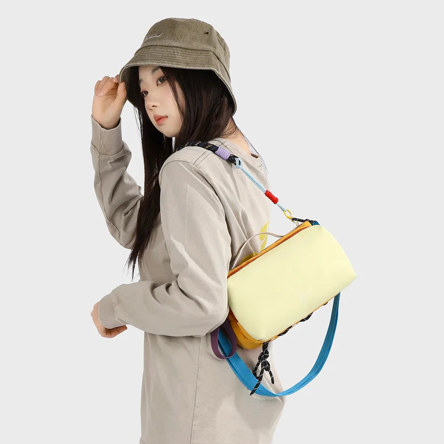 Color-block crossbody bag with rope handle — yellow worn on shoulder | BTendance