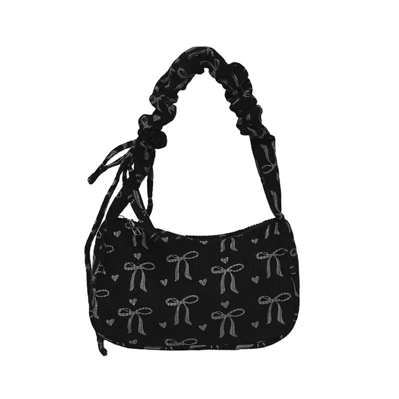 Bow-print corduroy shoulder bag with gathered handle — black front view on white background | BTendance
